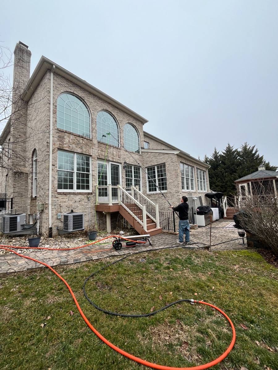Rejuvenate crew cleaning the windows of a large Maryland home